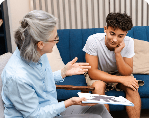 Counselor discussing with young man in therapy