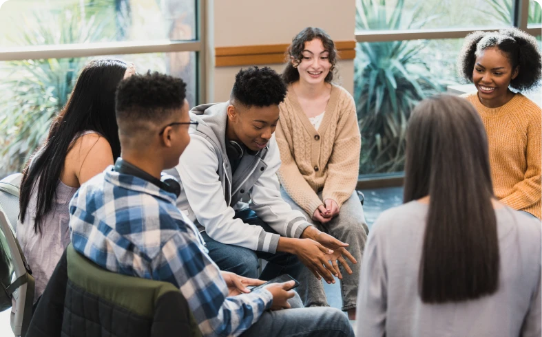 Friends sharing and laughing in a meeting